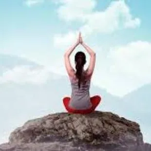 a woman doing yoga on a rock