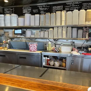 a view of a restaurant kitchen from the counter