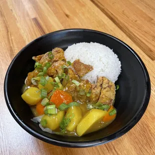 a bowl of food on a wooden table