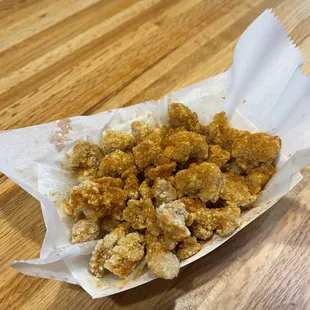 a basket of fried food on a wooden table