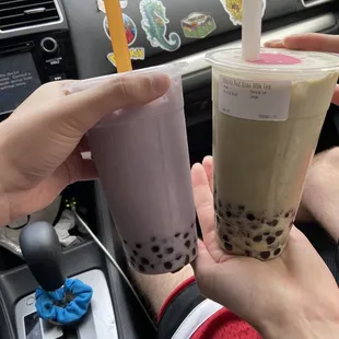 a person holding a drink in a car