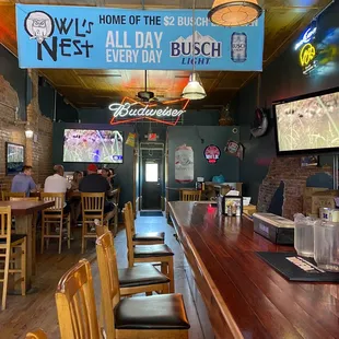 a restaurant with a bar and televisions