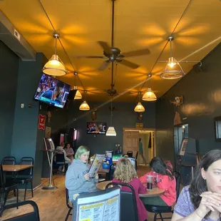 a group of people sitting at tables in a restaurant