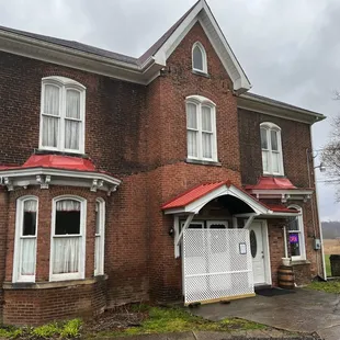 a brick building with a red roof