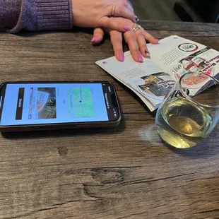 a glass of wine and a cell phone