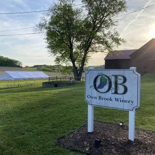 a sign in front of a barn