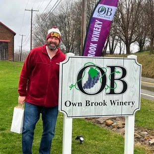 a man standing in front of a sign