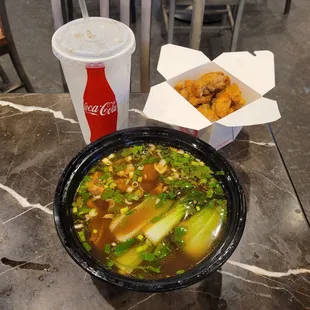 a bowl of soup and a drink