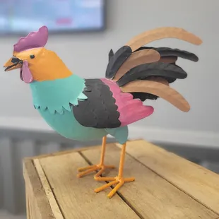 a colorful bird on a wooden table