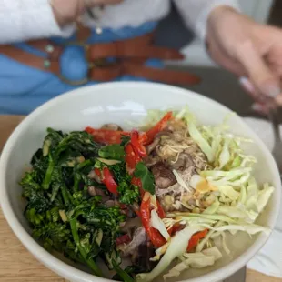 a woman eating a bowl of food