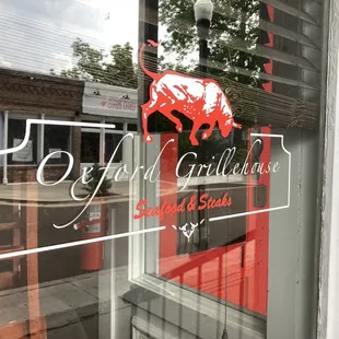 view of restaurant's logo on exterior window of business