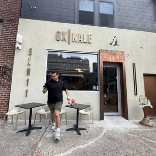 a man standing in front of a restaurant