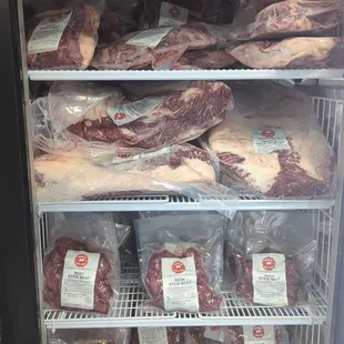 a display of meat in a refrigerator