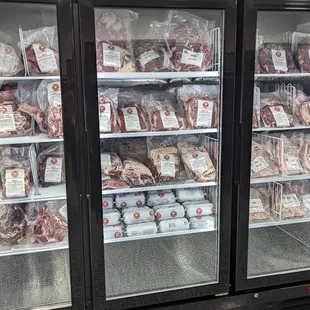 a display of meat in a refrigerator