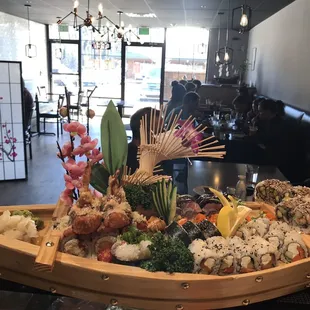 a boat of sushi and ramen