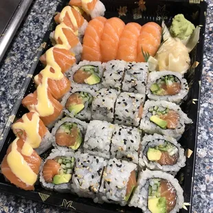 Golden roll on left, salmon nigiri, and 2 Alaska rolls. Take out this time.