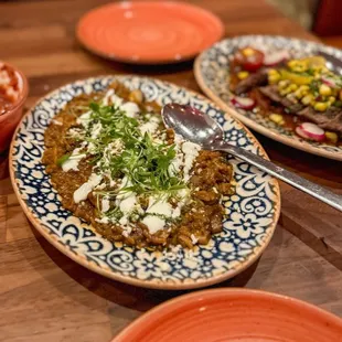 HONGOS EN MOLITO Wild mushrooms and Poblano peppers sauteed in a sauce of guajillo and pasilla chiles, Mexican crema, onions and cilantro