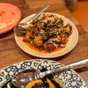 COLIFLOR FRITO Cauliflower in a smokey, rich almond salsa macha, mezcal raisins, rajas, over a hoja santa crema