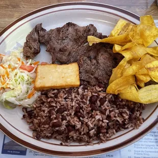 Carne asada with gallo pinto, queso frito, platano verde and salad