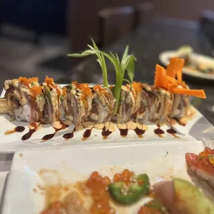 a plate of sushi and a glass of wine