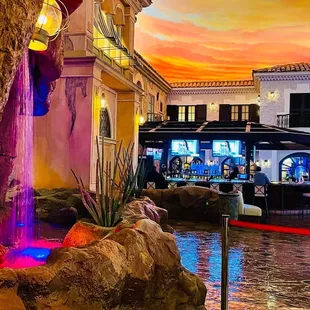 a colorful waterfall flowing down the side of a building