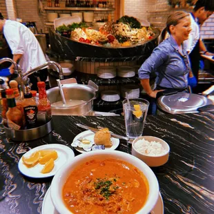 a bowl of soup and plates of food