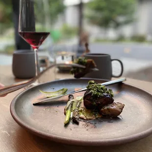 a plate of food and a glass of wine