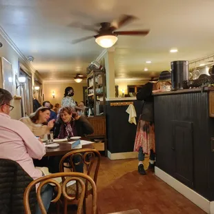 people sitting at tables in a restaurant