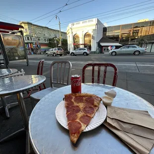a slice of pepperoni pizza on a paper plate