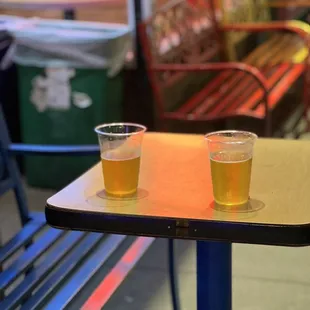 two glasses of beer on a table
