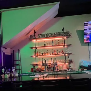 a bar with neon lights and a neon sign