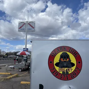a dog sitting on the side of a trailer
