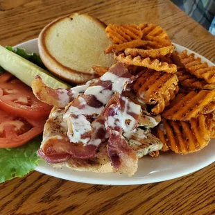 Chicken and bacon on a roll with sweet potato waffle fries