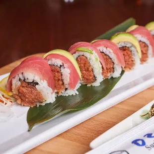 a plate of sushi on a wooden table