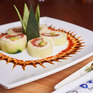 a plate of sushi and a knife