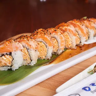 a plate of sushi on a wooden table