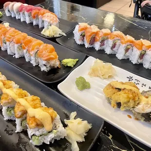 Las Vegas Roll (white plate) and a mix of Rainbow Rolls and Alaska Rolls