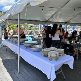 a group of people standing under a tent