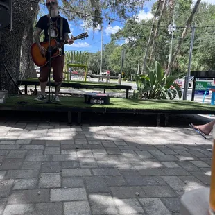 a man playing a guitar on stage