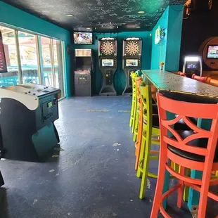 a bar with neon chairs