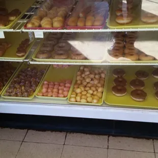 a variety of donuts in a display case