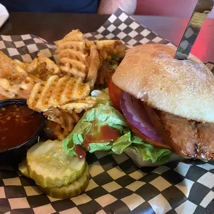 Cajun sausage sandwich with waffle fries