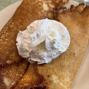a crepe with whipped cream on top