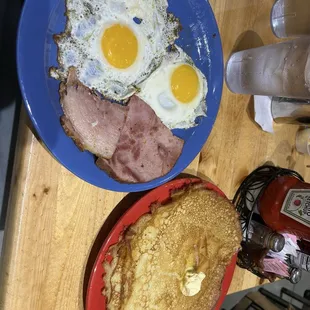 The morning after breakfast special (two sunny side up eggs, ham, and two crepe-style hotcakes)