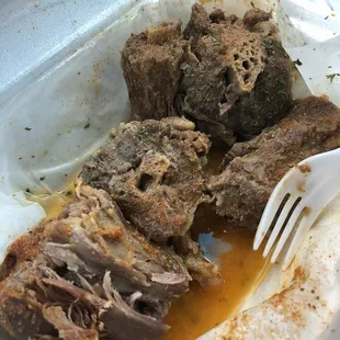 a piece of meat in a container with a fork