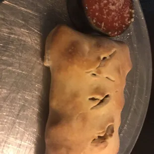 a piece of pie and a bowl of sauce