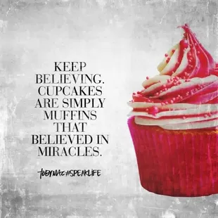 a cupcake with pink frosting and sprinkles