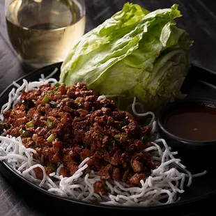  a plate of noodles and lettuce