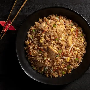  a bowl of fried rice and chopsticks
