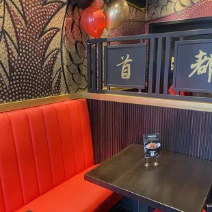  a booth with red booths and balloons